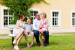 Family sitting in front of their home Family sitting in front of their home
