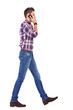 casual man talking on the phone and walking