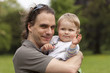 child on dads arms