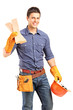 A smiling manual carpenter holding a helmet and sills A smiling manual carpenter holding a helmet and sills