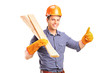 A smiling manual carpenter holding sills and giving thumb up A smiling manual carpenter holding sills and giving thumb up