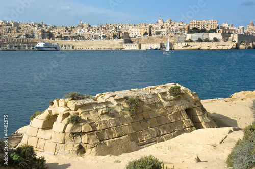 skyline of Valletta from Kalkara, in the foreground an old storage building constructed of sandstone blocks, Malta