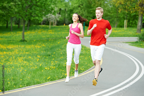 Photo: Young man and woman jogging outdoors Young man and woman jogging outdoors