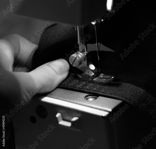 Photo: Hand of Seamstress Using Sewing Machine Hand of Seamstress Using Sewing Machine