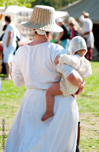 Photo: Medieval girl with a baby Medieval girl with a baby