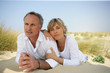 Couple lying in a sand dune Couple lying in a sand dune