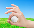 hand holds a ball for game in golf