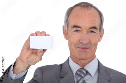 Photo: Man showing businesscard Man showing businesscard