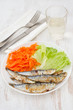 fried sardines with lettuce and carrot on the plate