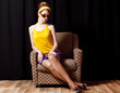 Redhead girl in armchair. 70s