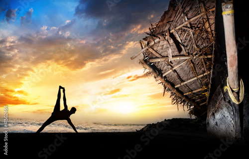 Photo: Man silhouette doing yoga Man silhouette doing yoga