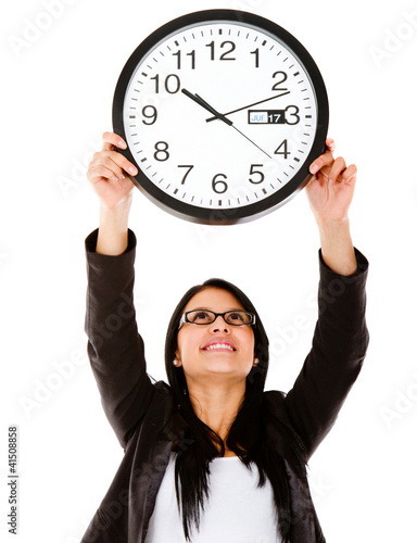 Photo: Business woman hanging a clock Business woman hanging a clock
