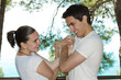 Foto: Young cute couple connected with their hands in love Young cute couple connected with their hands in love