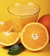 Orange juice and slices of orange isolated on yellow Orange juice and slices of orange isolated on yellow