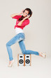 studio shot of young woman in headphones over grey studio shot of young woman in headphones over grey