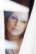 Sad woman looking through the window
