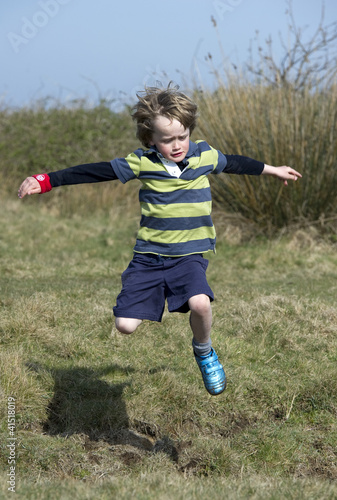 Photo: Boy jumping a ditch Boy jumping a ditch