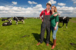canvas print picture - Typical Dutch landscape with farmer couple and cows