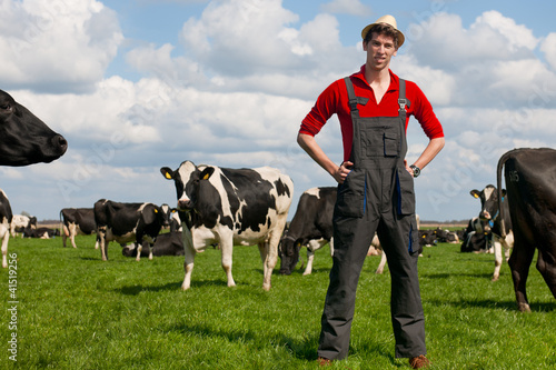 Photo: farmer in field with cows farmer in field with cows