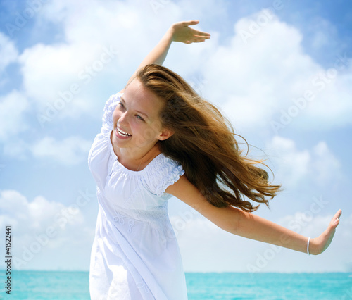 Photo: Beautiful Girl Having Fun on the Beach Beautiful Girl Having Fun on the Beach