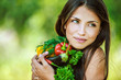 Photo: woman with bare shoulders holding vegetable woman with bare shoulders holding vegetable