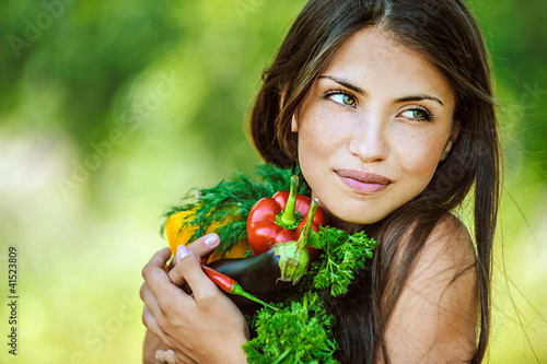 Photo: woman with bare shoulders holding vegetable woman with bare shoulders holding vegetable