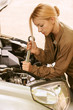 young woman repairing car