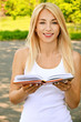young smiling woman reading book