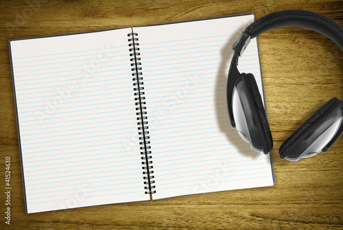Photo: open notebook and headphones open notebook and headphones