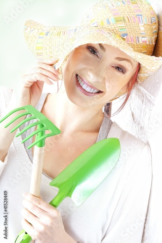Photo: portrait of woman with gardening tools portrait of woman with gardening tools
