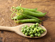 Wooden spoon with fresh peas