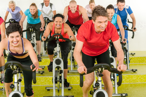 Photo: Spinning class sport people exercise at gym Spinning class sport people exercise at gym