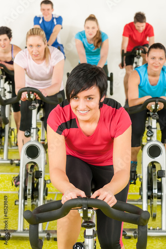 Photo: Spinning class sport people exercise at gym Spinning class sport people exercise at gym
