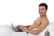 Photo: Nepalese young man in bed, laptop Nepalese young man in bed, laptop