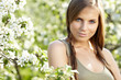 beautiful woman standing near the apple tree