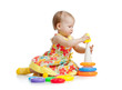 Photo: girl building pyramid on floor on white background girl building pyramid on floor on white background
