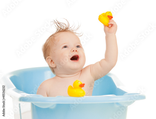 Photo: baby kid taking bath, looking upwards and playing baby kid taking bath, looking upwards and playing