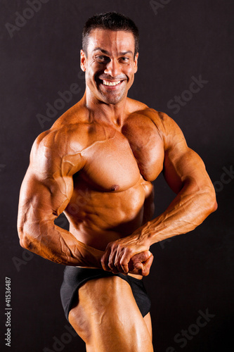 Photo: male bodybuilder on black background male bodybuilder on black background