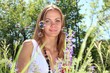 Beautiful young woman in the nature between soap bubbles