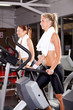 fitness women using stepper machine in gym