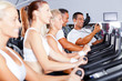 sport coach training cyclists in gym