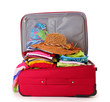 Open red suitcase with clothing isolated on a white
