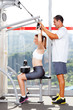 fitness woman in gym with personal trainer