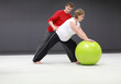 pregnant woman exercising with personal trainer