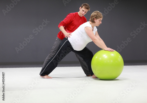 Photo: pregnant woman exercising with personal trainer pregnant woman exercising with personal trainer