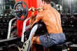 man working out with barbell in gym