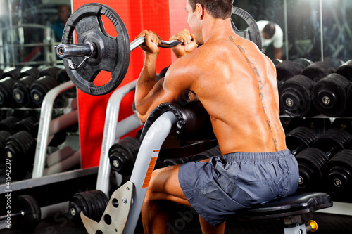 Photo: man working out with barbell in gym man working out with barbell in gym