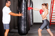 fitness woman training with punch bag in gym