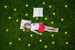 Cute little girl resting on pillows in summer garden