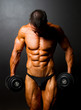 bodybuilder with dumbbells on black background